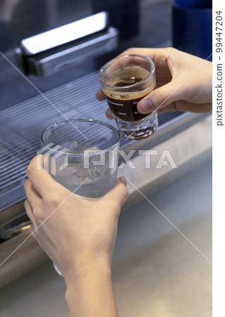 barista making, preparing coffee in cafe 99447204