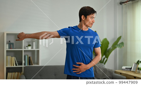Portrait of focused millennial man doing morning workout at home. Healthy lifestyle, sport and motivation concept 99447909