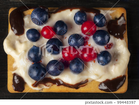 Square berry dessert for a buffet with blueberries and currants. Beautiful healthy cake. Square berry dessert for a buffet with blueberries and currants. Beautiful healthy cake. 99448397