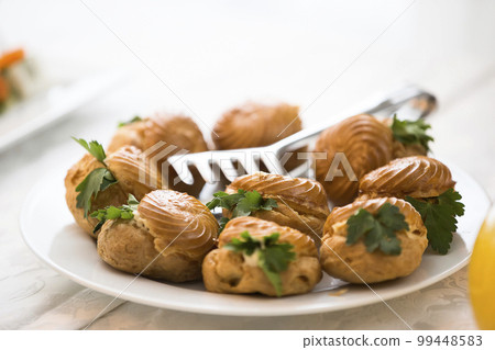 Buffet Dish. Choux pastry on the table Buffet Dish. Choux pastry on the table 99448583