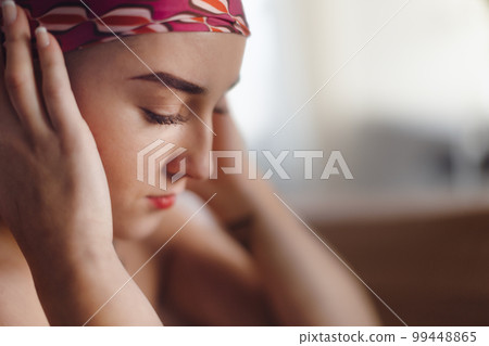 Portrait of unhappy pensive woman with cancer. 99448865