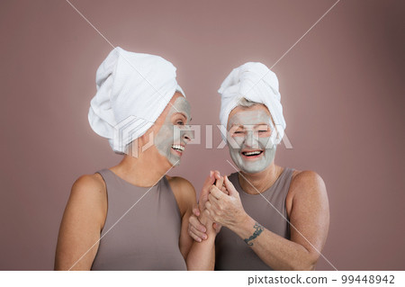 Portrait of happy senior friends with face-mask, selfcare and skin routine concept. Portrait of happy senior friends with face-mask, selfcare and skin routine concept. 99448942