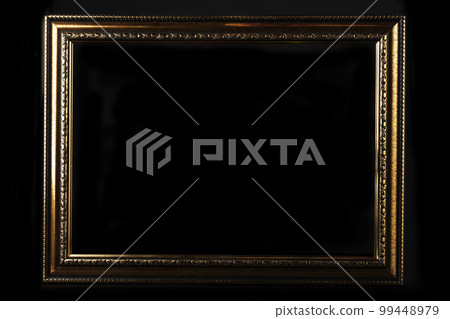 Golden classic blank frame on black background. 99448979