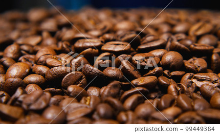 Close-up of roasted coffee beans. Selective focus. Concept of a coffee shop. Coffee as a way of life. Close-up of roasted coffee beans. Selective focus. Concept of a coffee shop. Coffee as a way of life. 99449384