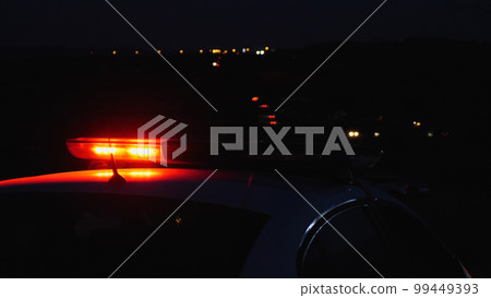 Close-up of a police blinker. The red rotating beacon on the roof of a police patrol car flashes brightly in the dark. Safety on the roads and protection of people. Close-up of a police blinker. The red rotating beacon on the roof of a police patrol car flashes brightly in the dark. Safety on the roads and protection of people. 99449393