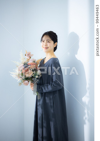 A woman holding a bouquet A woman holding a bouquet 99449463