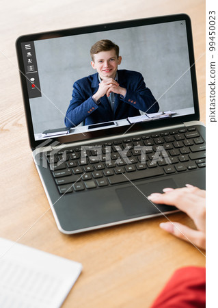 Web conference. Video interview. Internet meeting. Business partners discussing work online on laptop screen at digital office workplace. 99450023