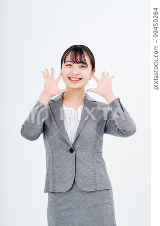 Young woman in a suit smiling 99450264