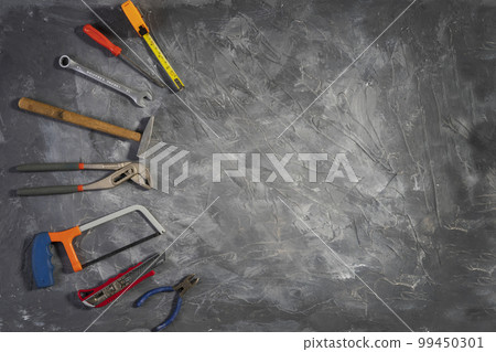 Toolkit for work in the home on gray wooden background 99450301