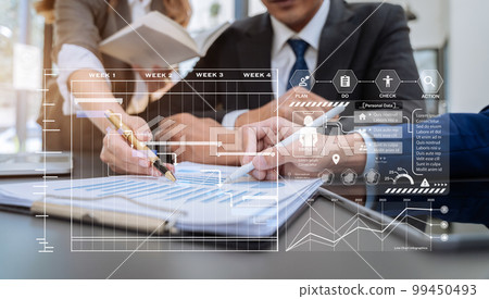 Businessmen team or financial data analysts working with tablets and laptop computers and data graphs together. Plan to analyzing projects in the office. 99450493