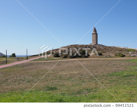 Grassy hill with tower of Hercules in A Coruna city at Galicia, Spain 99451521