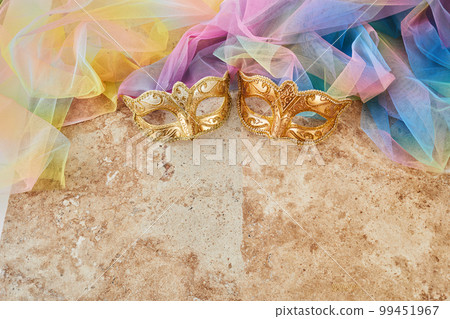 Purim celebration concept. Jewish carnival background. hamantaschen or hamans ears cookies, carnival mask and noisemaker 99451967
