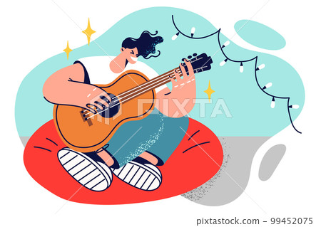 Man guitarist sits in chair with legs folded and plays guitar inventing own music 99452075