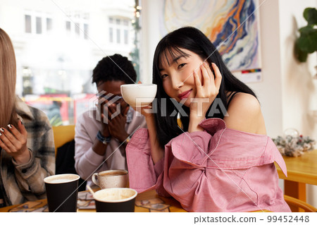 laughing friends eating pizza and having fun. They are enjoying eating and  drinking together Stock Photo