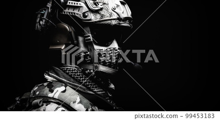 Modern army special forces equipped soldier, anti terrorist squad fighter, elite mercenary in helmet, studio portrait in darkness. Close up, half length 99453183