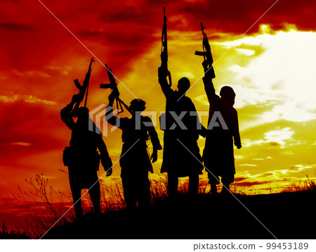 Silhouette of several muslim militants with rifles 99453189