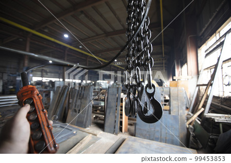 Metal industrial chains with hooks in the workshop of a metallurgical plant. Metal industrial chains with hooks in the workshop of a metallurgical plant. 99453853