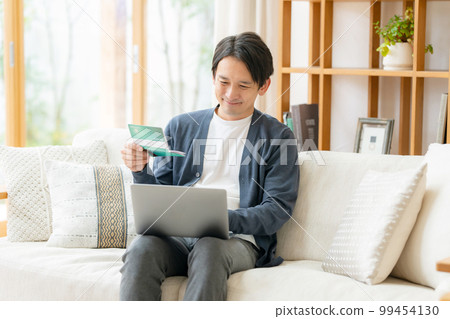 A man who is happy to see passbooks 99454130