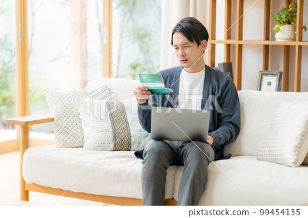 A man who is worried about looking at the passbook 99454135