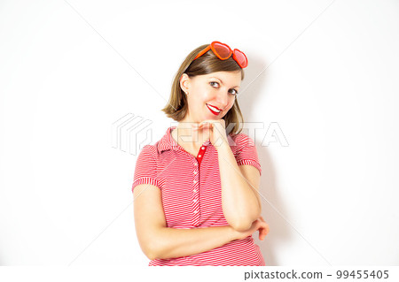 Attractive young girl with red heart sunglasses standing and smiling. Valentines Day concept. High quality photo. 99455405