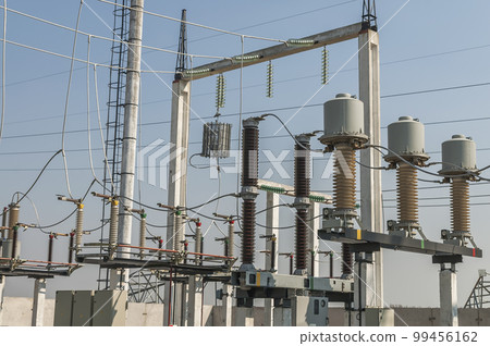 Part of high-voltage substation on blue sky background with switches and disconnectors. Ukrainian energy infrastructure. 99456162