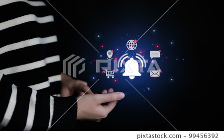 Woman using smartphone with virtual bell ringing for application notification alert concept. social media and internet network, email, telephone, chat, shopping online, map location, 99456392
