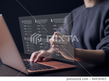 Woman with evaluating questionnaire on online laptop computer. assessment survey online, choose correct answer in test, questions test, online exam, quiz knowledge, filling out a survey form business. 99456403