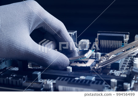 Repairman computer Installation CPU on socket of the motherboard in laboratory. CPU computer processor shallow focus. maintenance or repair. computer upgrade, Computer technology hardware concept. 99456499
