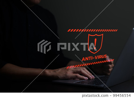 Concept of antivirus alert and firewall hacker protection safety. Businessman or personnel, programmer, or developer is using a computer laptop with an exclamation mark and a shield red sign. 99456554