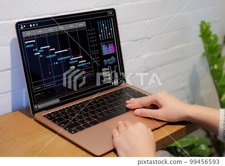 Analyst working on laptop computer. Business Analytics chart and data management System to make report with KPI and metrics connected to database. Corporate strategy for finance, and schedule planning Analyst working on laptop computer. Business Analytics chart and data management System to make report with KPI and metrics connected to database. Corporate strategy for finance, and schedule planning 99456593