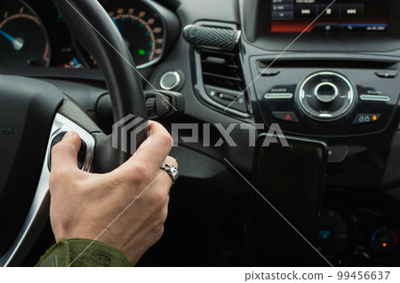 Man driving car. Auto interior. Man hand on steering wheel. Auto dashboard. Journey concept. Personal transport. Inside the car. Speed background. Driver in car. Man driving car. Auto interior. Man hand on steering wheel. Auto dashboard. Journey concept. Personal transport. Inside the car. Speed background. Driver in car. 99456637