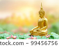 Makha Asanaha Visakha Bucha Day Golden Buddha image. Background of Bodhi leaves with shining light. Soft image and smooth focus style 99456756