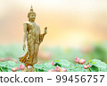 Makha Asanaha Visakha Bucha Day Golden Buddha image. Background of Bodhi leaves with shining light. Soft image and smooth focus style 99456757