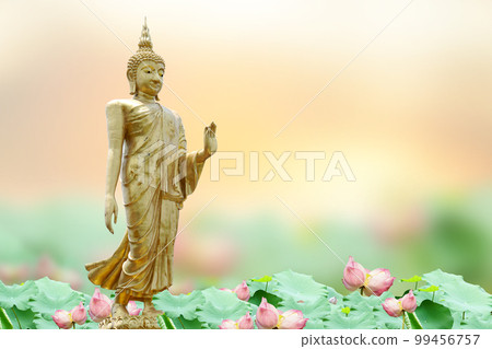 Makha Asanaha Visakha Bucha Day Golden Buddha image. Background of Bodhi leaves with shining light. Soft image and smooth focus style 99456757