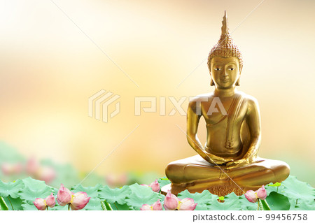 Makha Asanaha Visakha Bucha Day Golden Buddha image. Background of Bodhi leaves with shining light. Soft image and smooth focus style 99456758