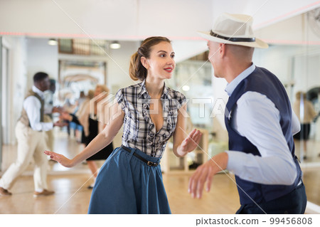 Pair dancing lindy hop during rehearsal 99456808