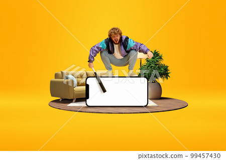 Emotional active man sitting on giant 3D model of mobile phone with empty screen for ad, text. Online sport match, betting. Mockup for design, logo. 99457430
