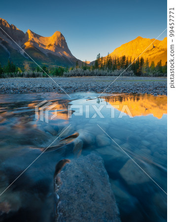 Landscape during sunrise. Autumn trees on the river bank. Mountains and forest. Landscape during sunrise. Autumn trees on the river bank. Mountains and forest. 99457771