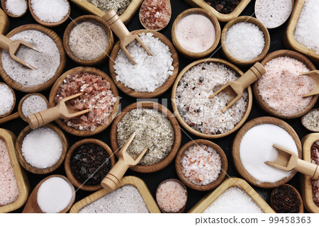 Colorful mix of salt varieties: sea and black, table and pink, himalayan and celtic. Food ingredients on dark background Colorful mix of salt varieties: sea and black, table and pink, himalayan and celtic. Food ingredients on dark background 99458363