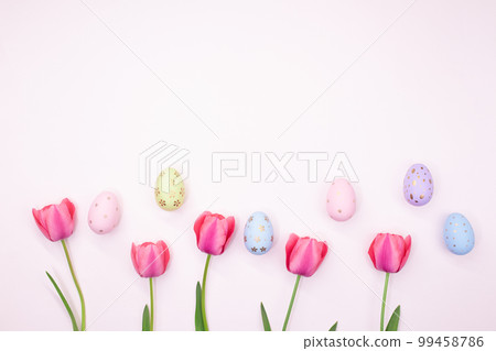 Pink tulips with painted eggs with place for text. Easter, spring. Pastel background. Copy space Pink tulips with painted eggs with place for text. Easter, spring. Pastel background. Copy space 99458786