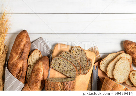 slide multi grain sourdough bread and sliced Baguette on white wood slide multi grain sourdough bread and sliced Baguette on white wood 99459414