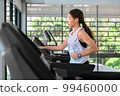 young happy asian woman athlete run on treadmill, running machine, in indoor gym fitness for health; 99460000