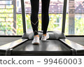 young happy asian woman athlete run on treadmill, running machine, in indoor gym fitness for health; 99460003