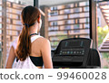 young happy asian woman athlete run on treadmill, running machine, in indoor gym fitness for health; 99460028