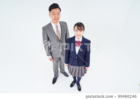 A man in a suit and a high school girl A man in a suit and a high school girl 99460246