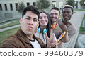 Diverse cheerful friends taking selfie together in the afternoon 99460379
