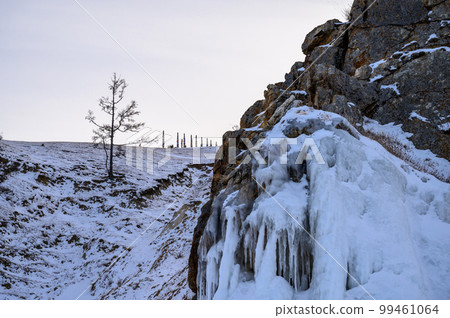 Serge on the mountain. evening light through the trees and rocks. Winter Baikal. Small sea. Serge on the mountain. evening light through the trees and rocks. Winter Baikal. Small sea. 99461064