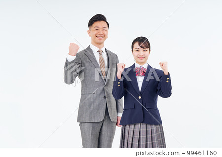 A man and a high school girl in a suit doing a guts pose 99461160