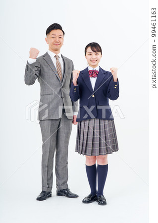 A man and a high school girl in a suit doing a guts pose 99461163