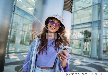 Young caucasian girl smiling happy using smartphone at city. 99461405